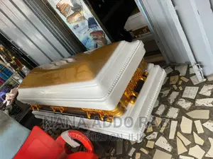 Proudly Made in Ghana Casket Gold Handles and White Interior