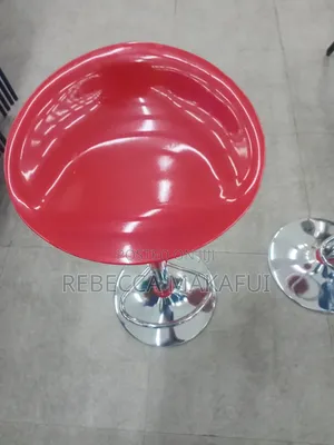 Red Bar Stool With Silver Base and Footrest .