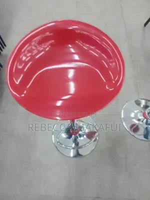 Red Bar Stool With Silver Base and Footrest .