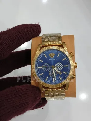 Gold and Silver Versace Men's Watch With a Blue Face.