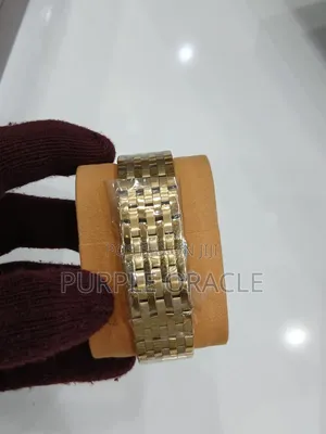 Gold and Silver Versace Men's Watch With a Blue Face.