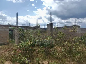 Uncompleted Building Building on Two Plots of Land