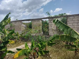 Uncompleted Building Building on Two Plots of Land