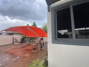 Orange Carport to Match Roofing