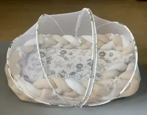 Baby Bed With a Mosquito Net and a Braided Bumper Guard.