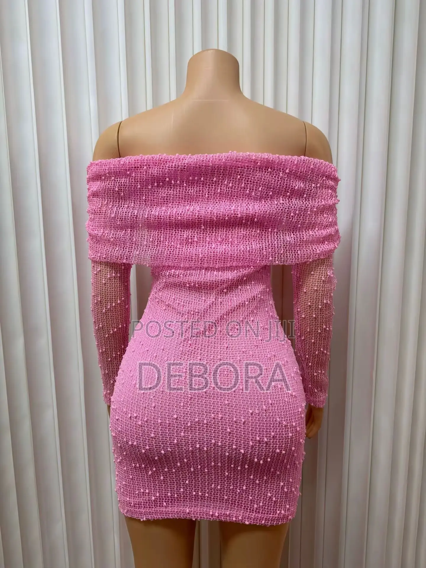 Bodycon Mini Dress With an Off-Shoulder Neckline and Long Sleeves.