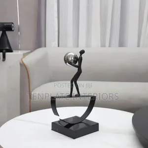Man Balancing With Ball Sculpture