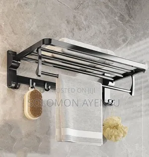 Wall-mounted Black Towel Rack With A Shelf And Multiple Bars.