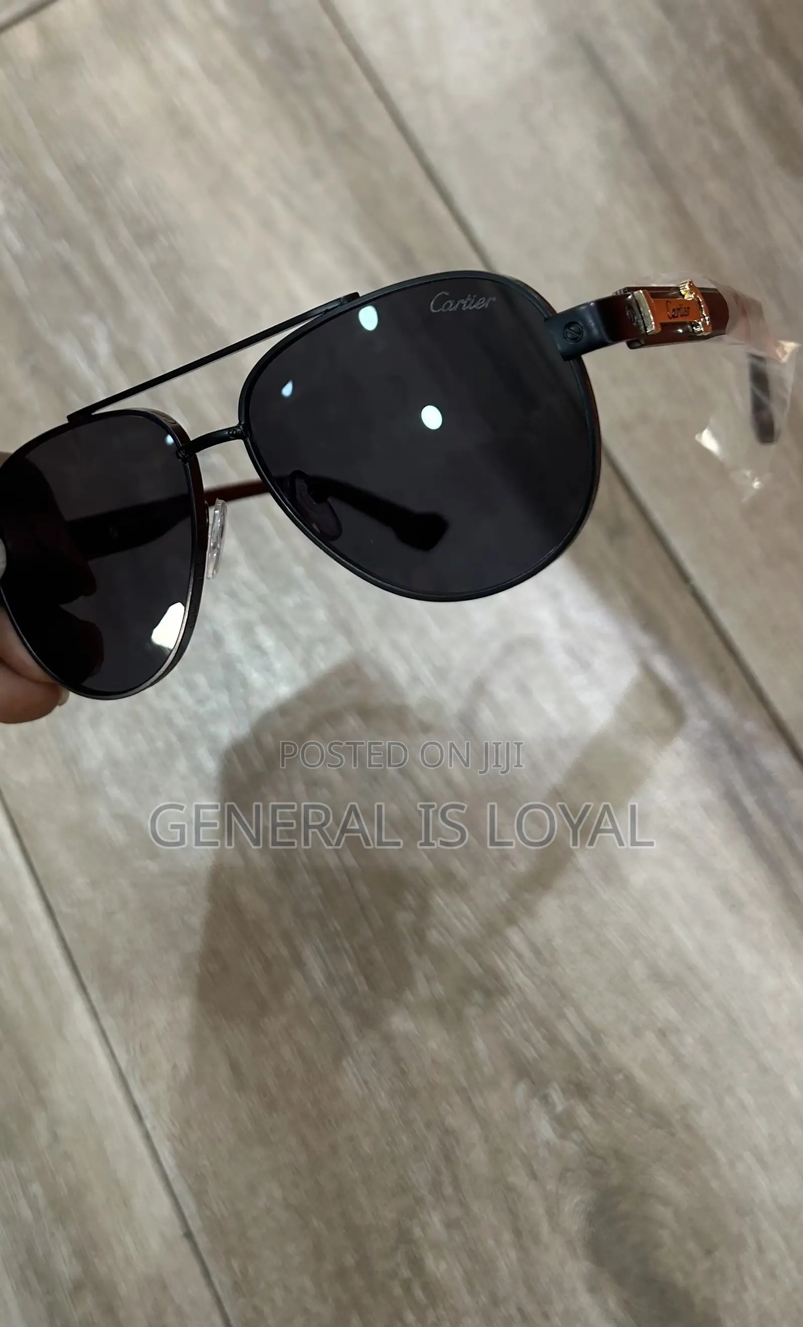 Cartier Aviator Sunglasses With A Black Metal Frame And Dark Lenses.