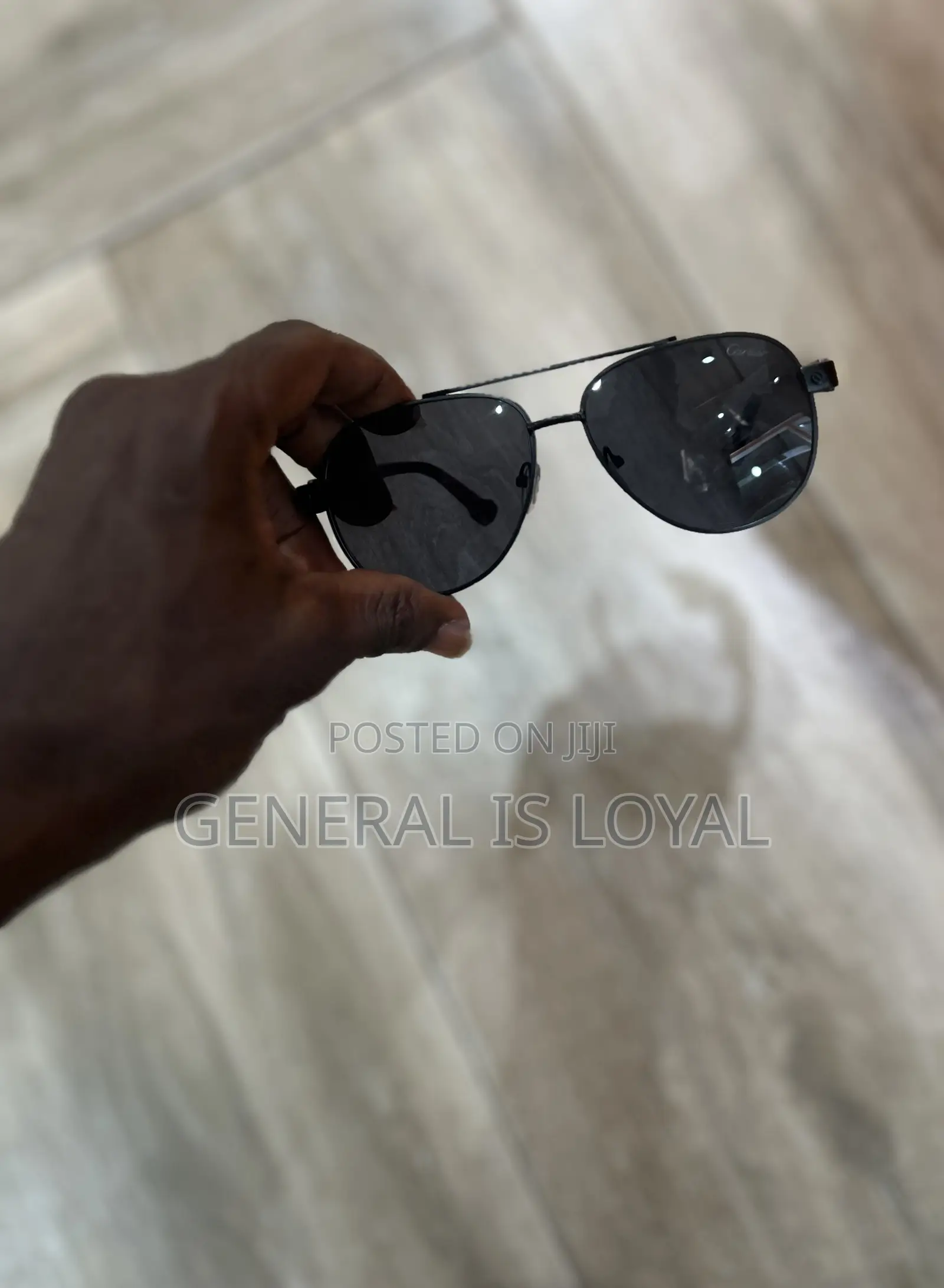 Cartier Aviator Sunglasses With A Black Metal Frame And Dark Lenses.