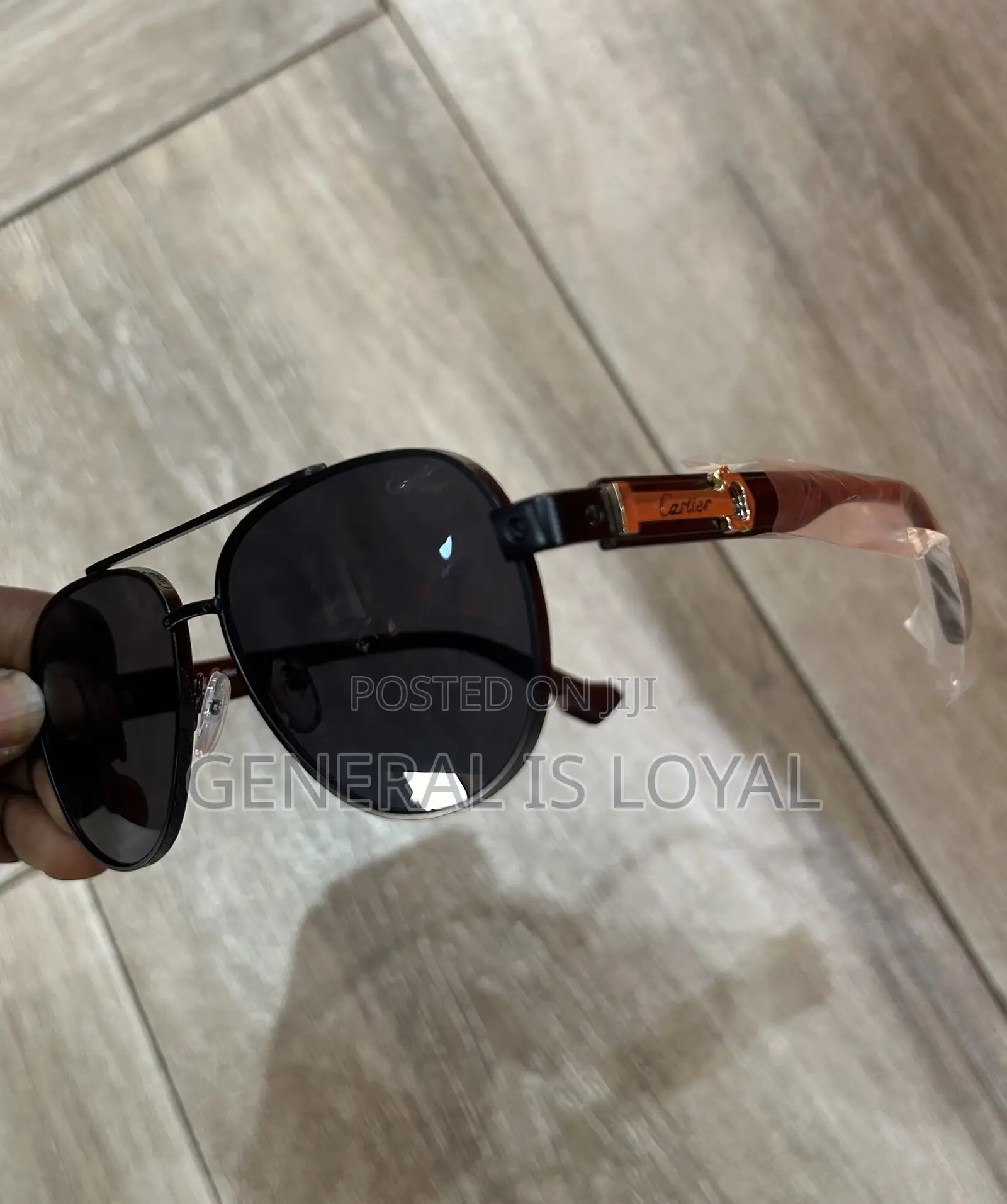 Cartier Aviator Sunglasses With A Black Metal Frame And Dark Lenses.