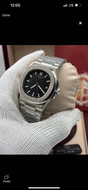 Patek Philippe Silver Stainless Steel Nautilus Watch  Black Dial.