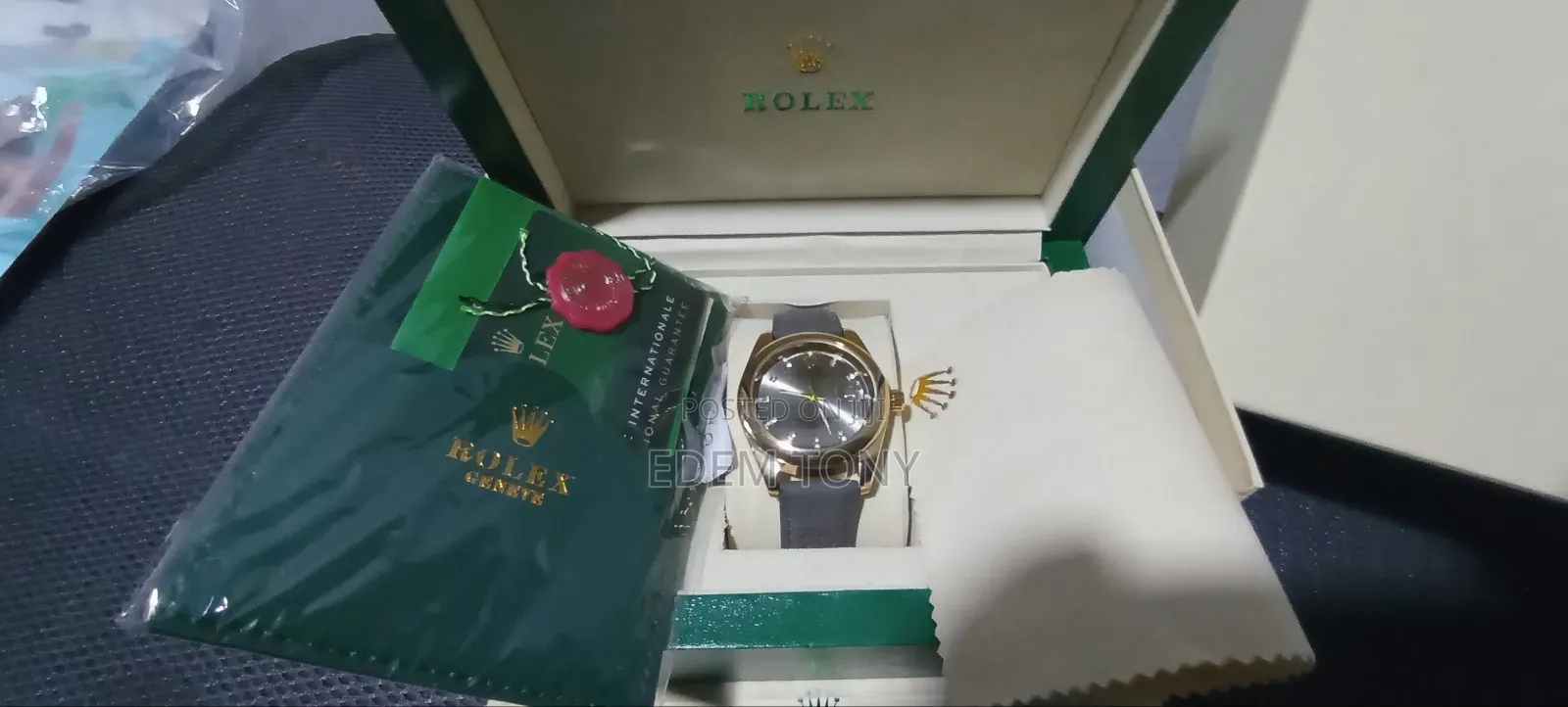 A Gold-Tone Rolex Watch With a Grey Strap