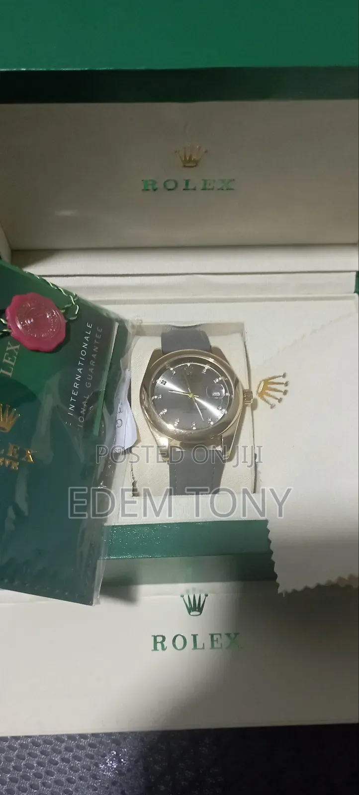 A Gold-Tone Rolex Watch With a Grey Strap