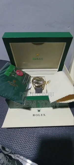 A Gold-Tone Rolex Watch With a Grey Strap