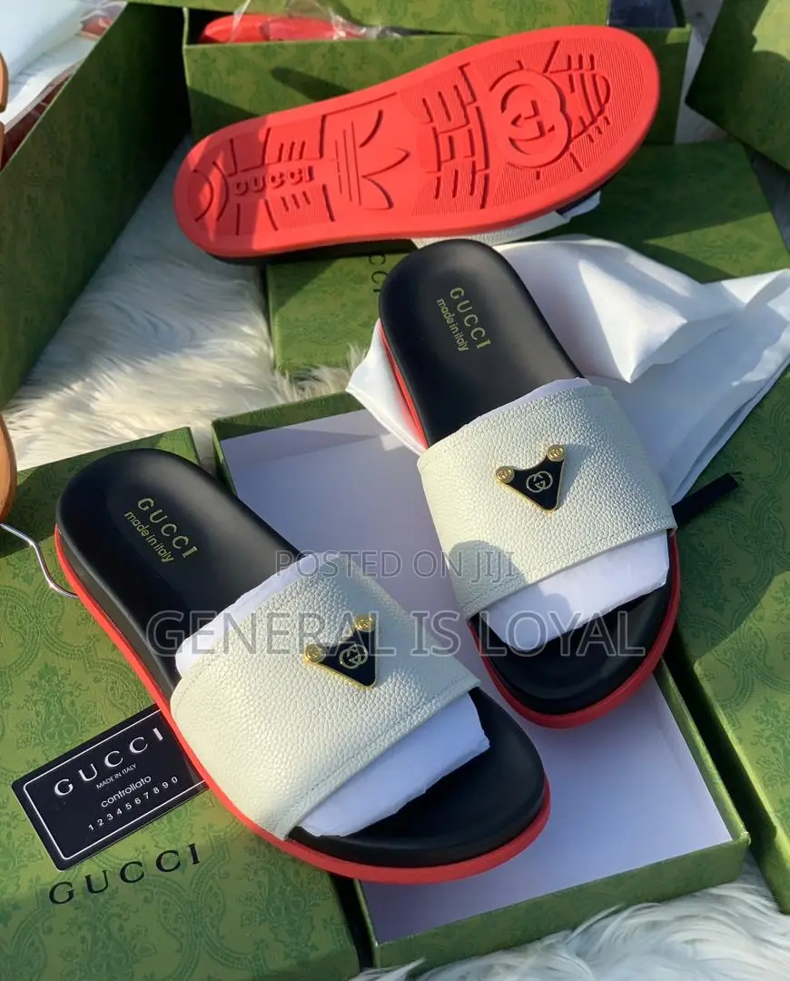 Gucci Slide Sandals With A White Strap, Black Footbed, And Red Sole