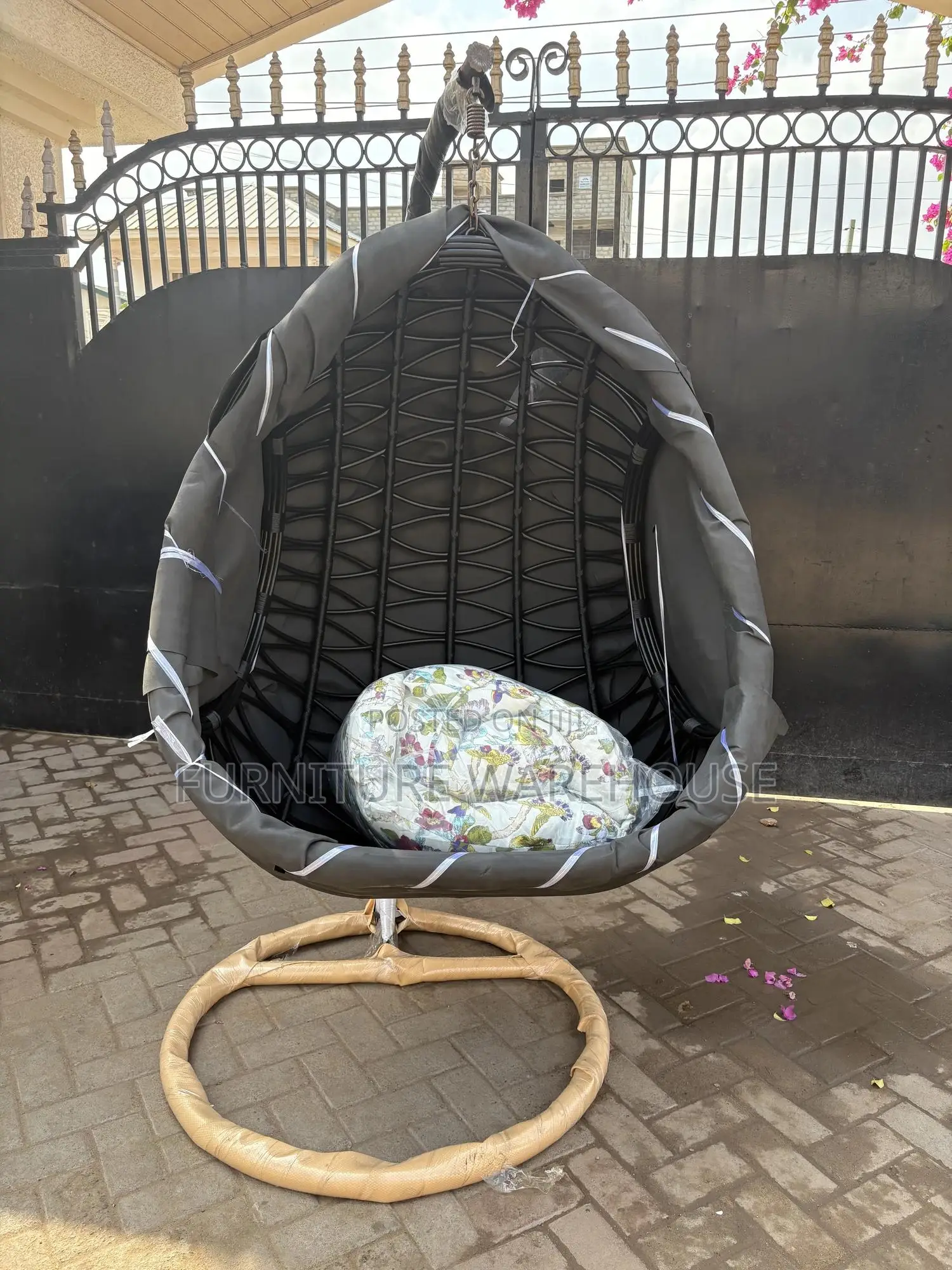 Rattan Hanging Egg Chair With A Floral Cushion