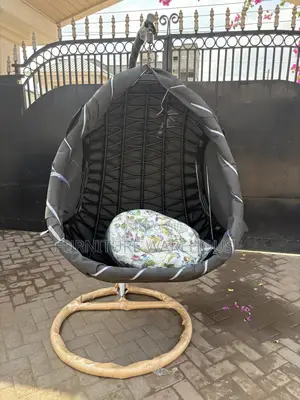 Rattan Hanging Egg Chair With A Floral Cushion