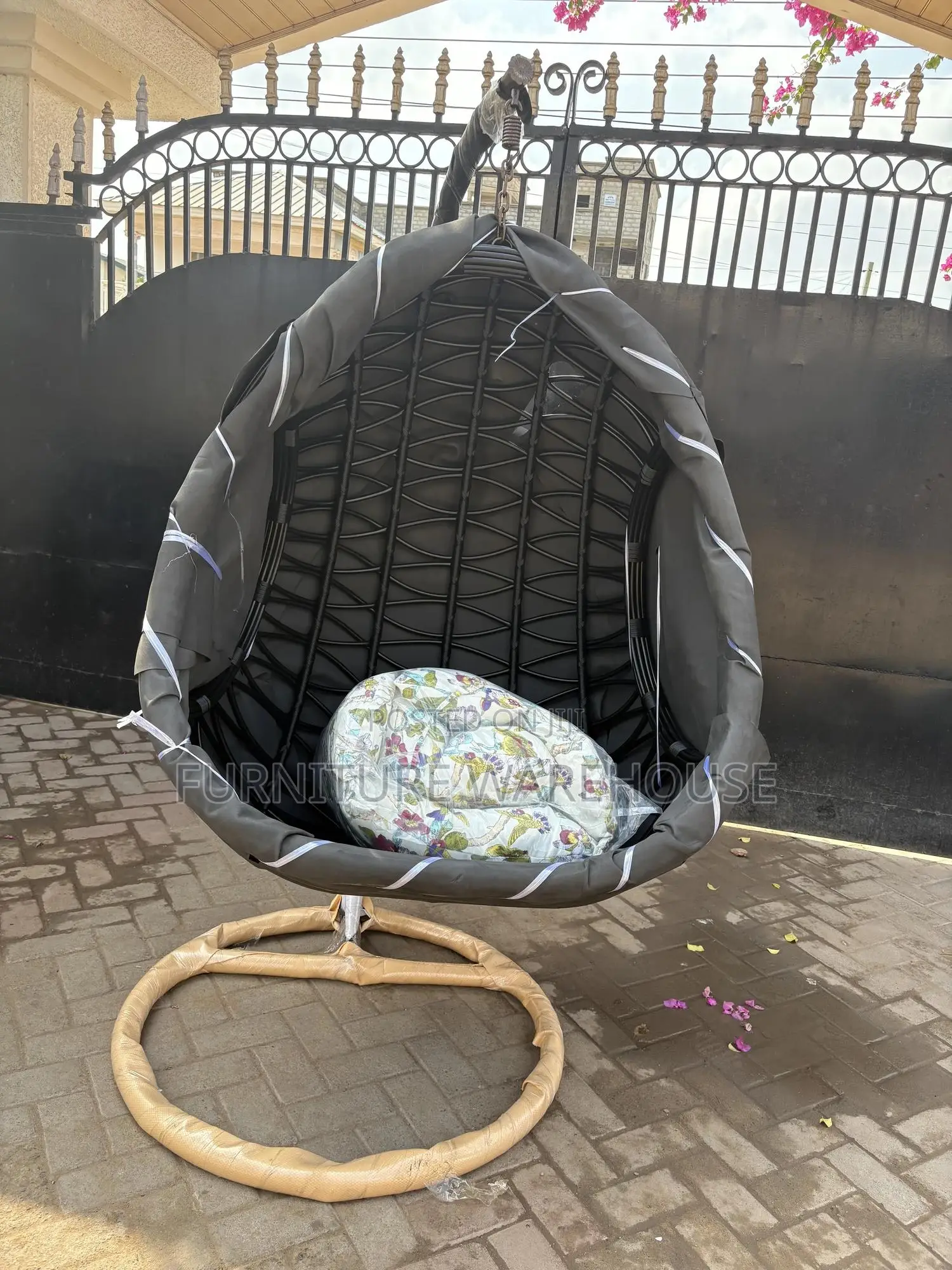Rattan Hanging Egg Chair With A Floral Cushion