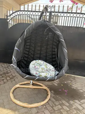 Rattan Hanging Egg Chair With A Floral Cushion