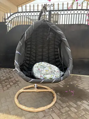 Rattan Hanging Egg Chair With A Floral Cushion