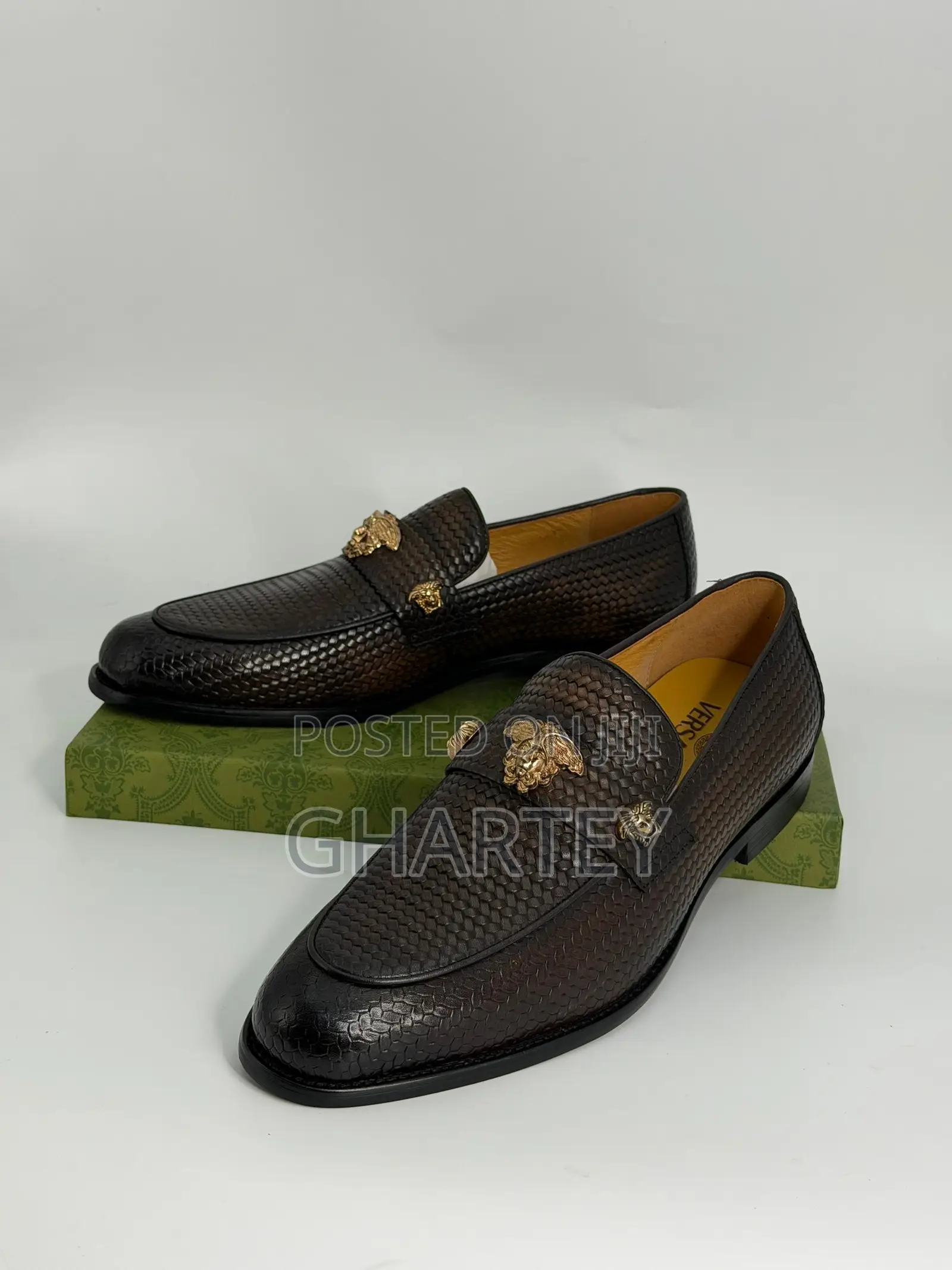 Luxury Textured Leather Loafers With Gold Crest Detail