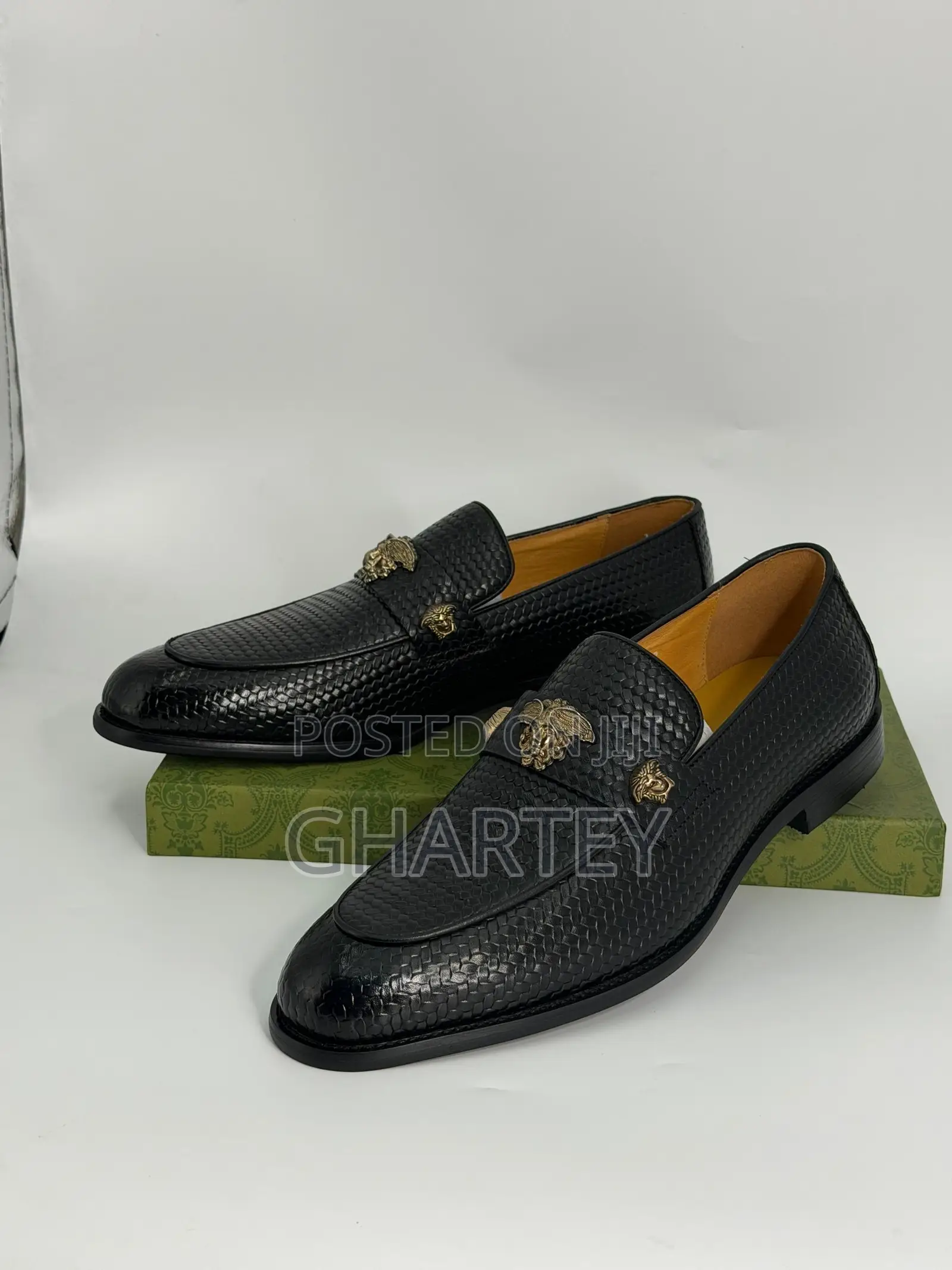 Luxury Textured Leather Loafers With Gold Crest Detail