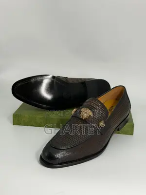 Luxury Textured Leather Loafers With Gold Crest Detail