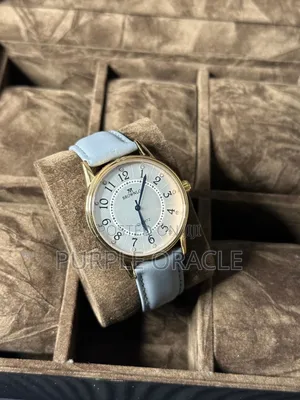 Brownlo Quartz Watch With A White Dial And Light Blue Leather Strap.
