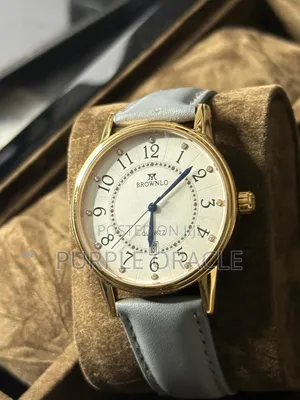 Brownlo Quartz Watch With A White Dial And Light Blue Leather Strap.