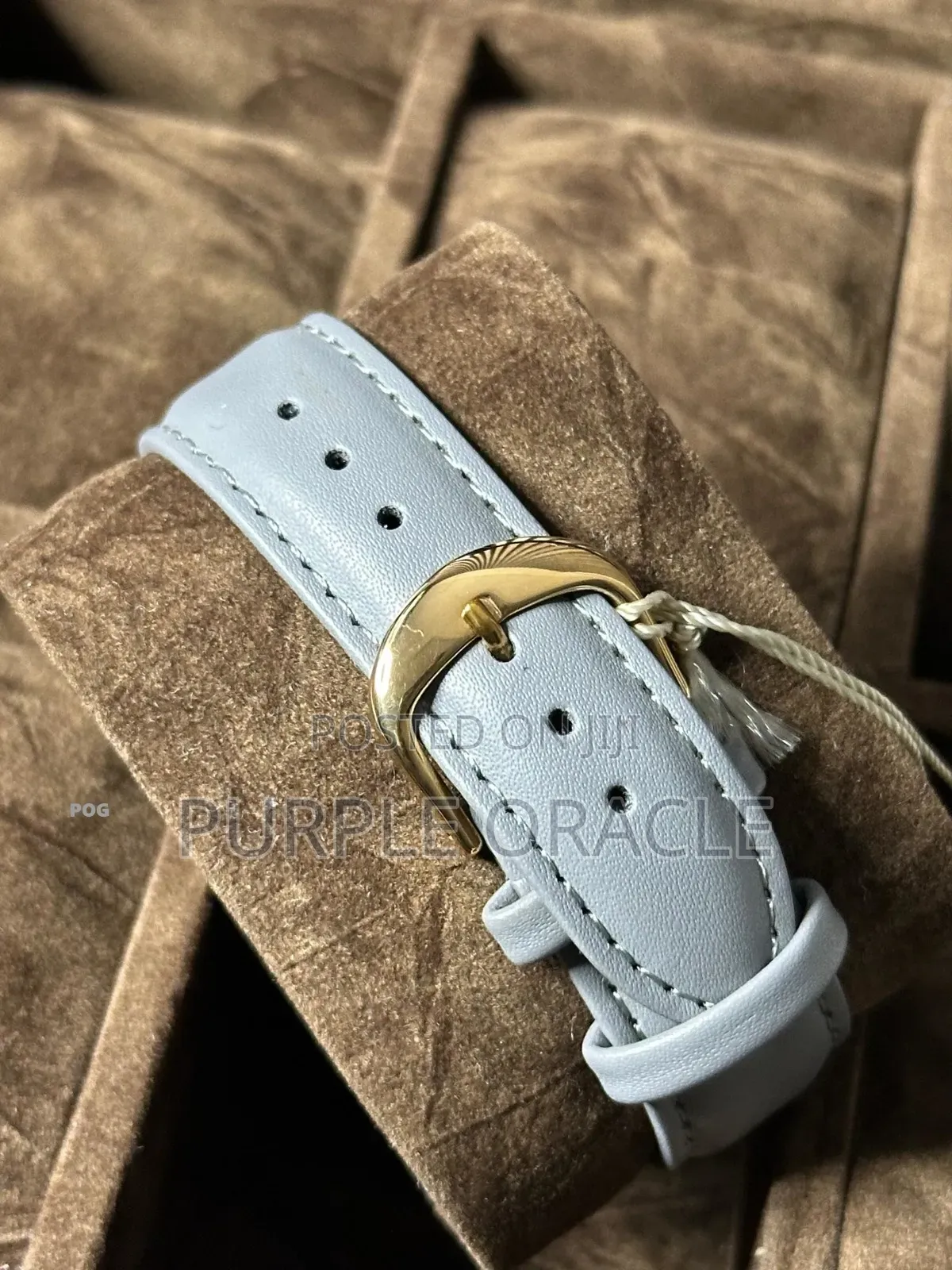 Brownlo Quartz Watch With A White Dial And Light Blue Leather Strap.