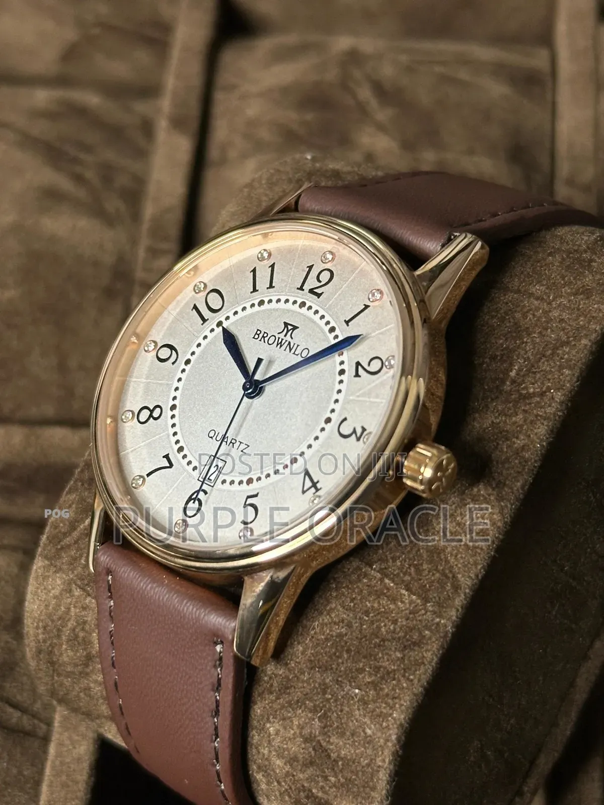 Brownlo Quartz Watch With A Gold-tone Case And A Brown Leather Strap.
