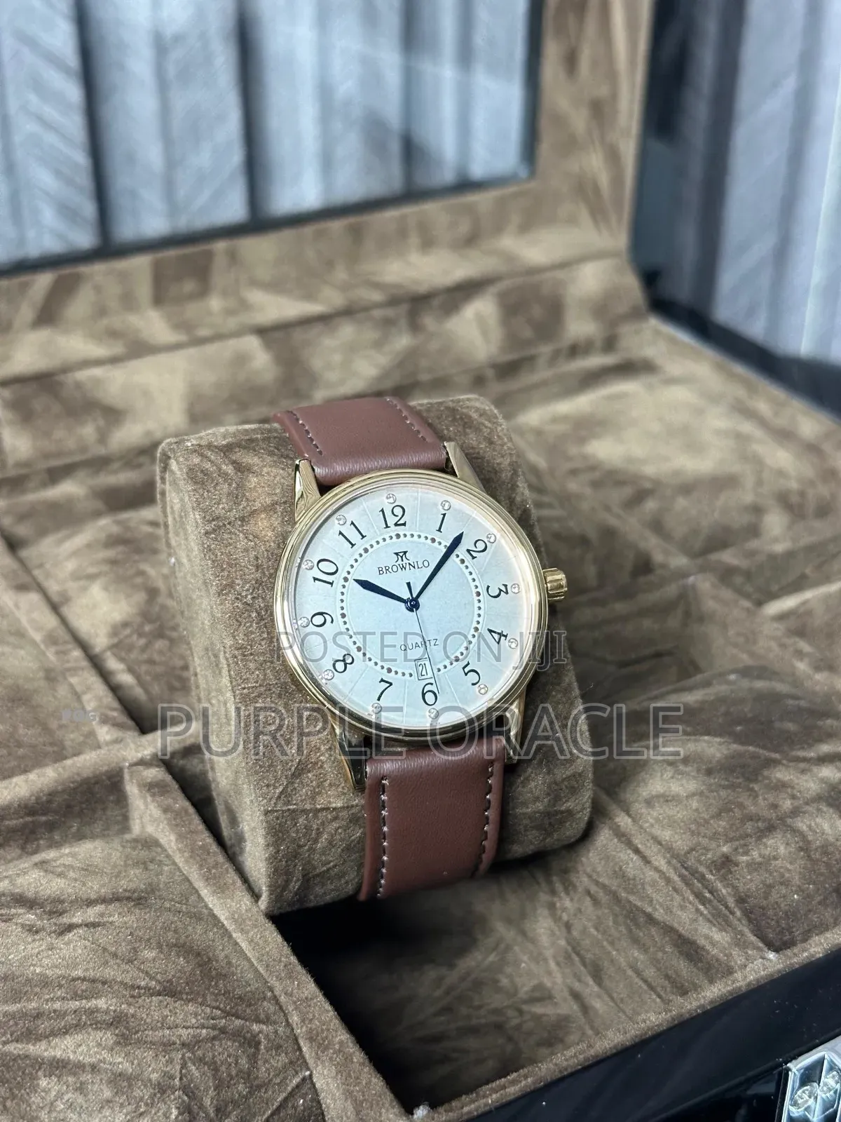 Brownlo Quartz Watch With A Gold-tone Case And A Brown Leather Strap.
