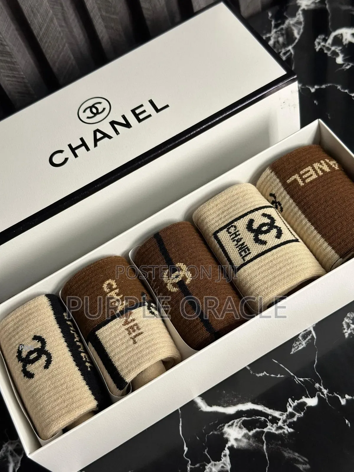 Chanel-branded Socks In A Variety Of Neutral Colors.