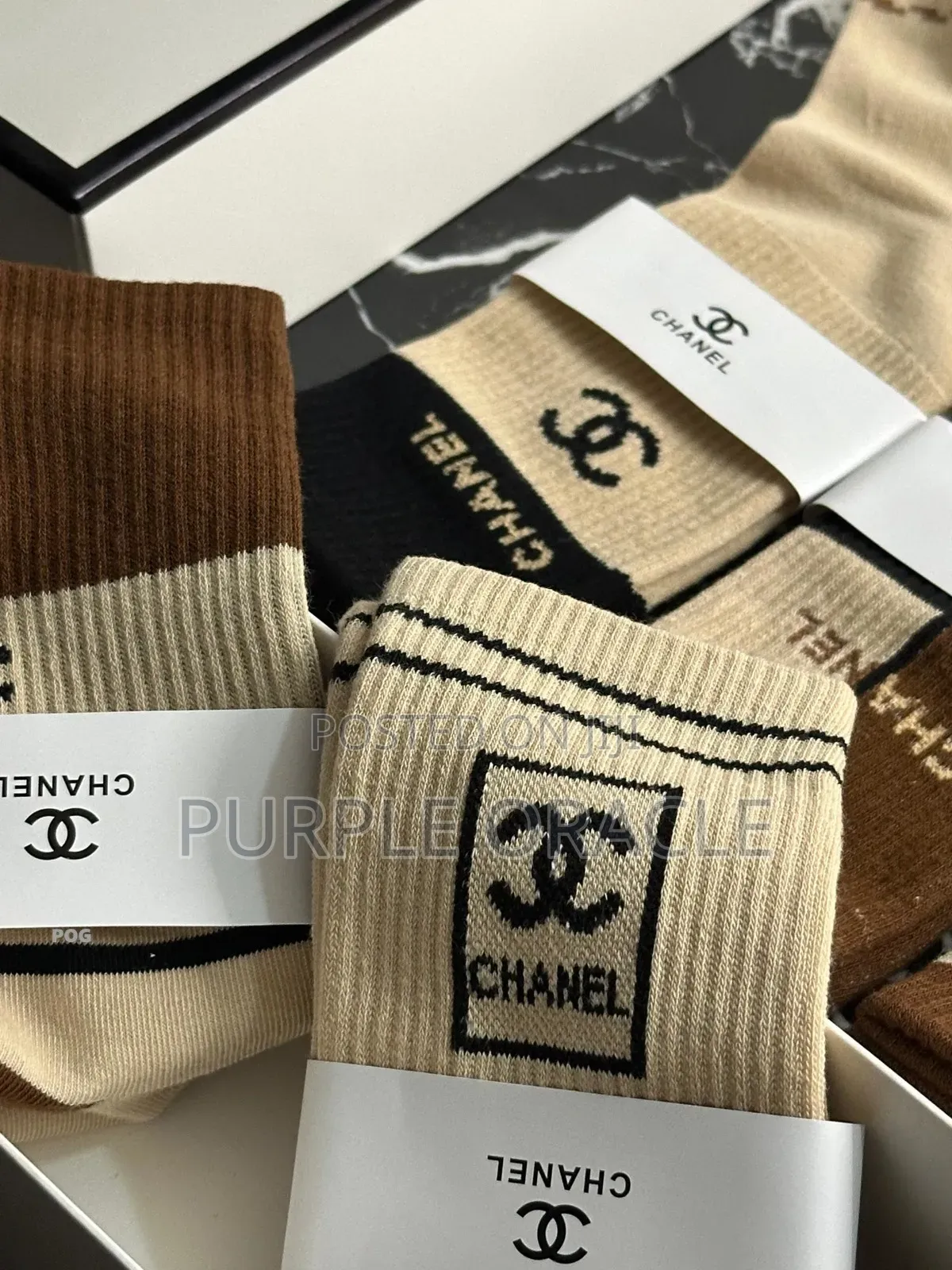 Chanel-branded Socks In A Variety Of Neutral Colors.