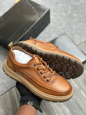 Brown Leather Casual Sneakers With a Lace-Up Design.