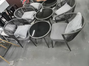 Rope-Woven Armchairs and a Round Bistro Table With Tempered Glass Top.