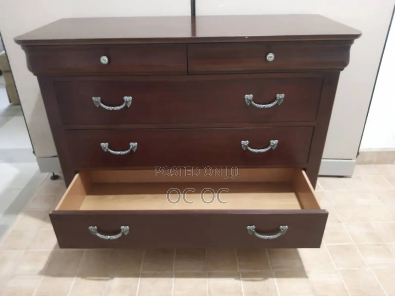 Dark Wood Dresser Features Decorative Silver Handles