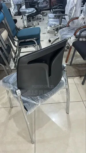 Black Padded Office Chair With a Chrome Metal Frame.