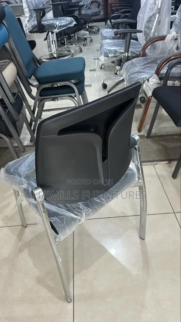 Black Padded Office Chair With a Chrome Metal Frame.