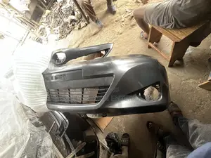 Toyota Vitz 2012 Front Bumper With Lower Grille Attached to It