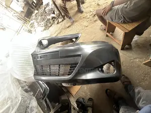 Toyota Vitz 2012 Front Bumper With Lower Grille Attached to It