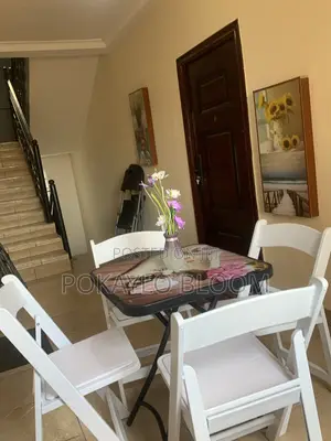 Table With a Decorative Glass Top With 4 Kinds of Folding Chairs.
