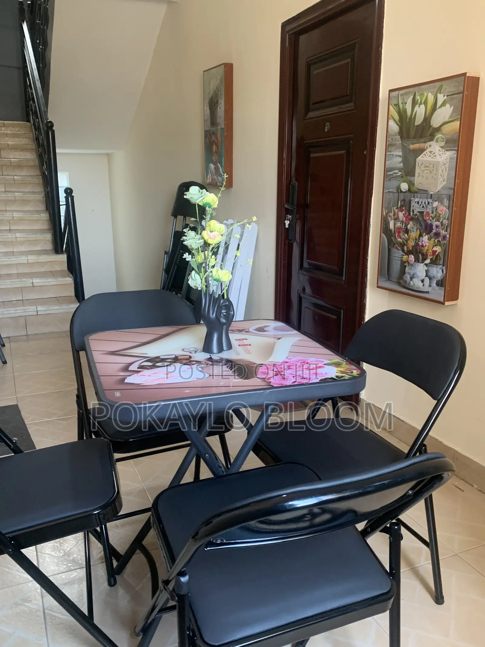 Table With a Decorative Glass Top With 4 Kinds of Folding Chairs.