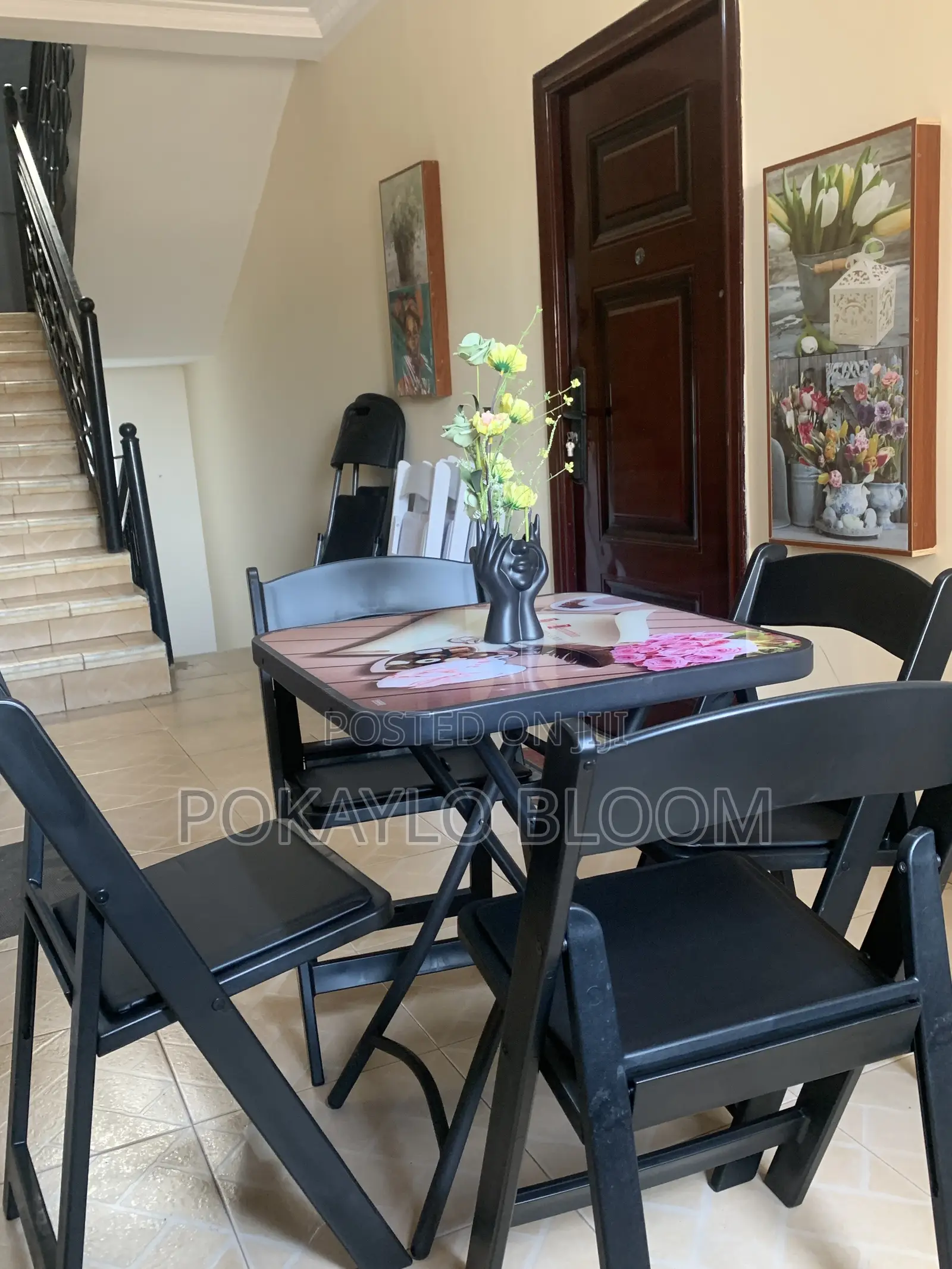 Table With a Decorative Glass Top With 4 Kinds of Folding Chairs.