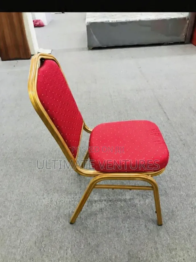 Stacked Gold Frame Banquet Chairs With Red Cushions