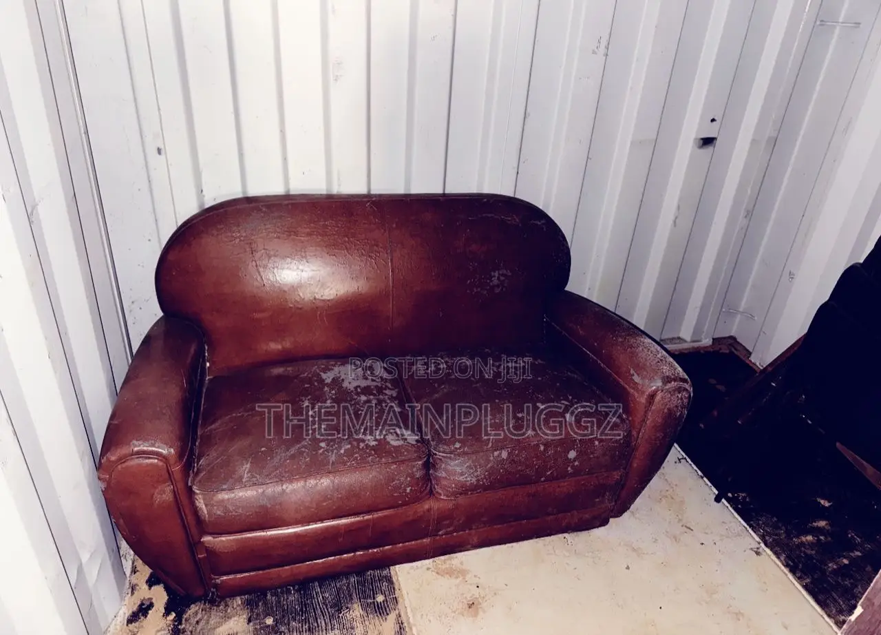 Brown Leather Club Sofa Features Rounded Arms