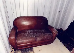 Brown Leather Club Sofa Features Rounded Arms