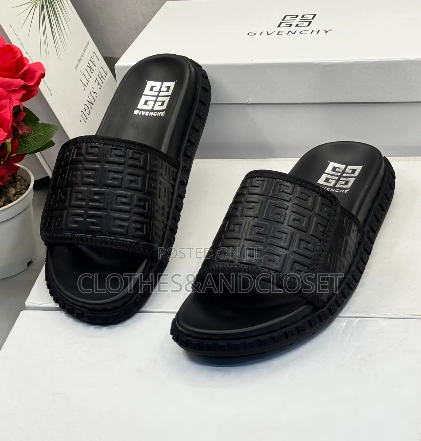 Black Givenchy Slides Feature a Prominent Monogram Embossed Pattern