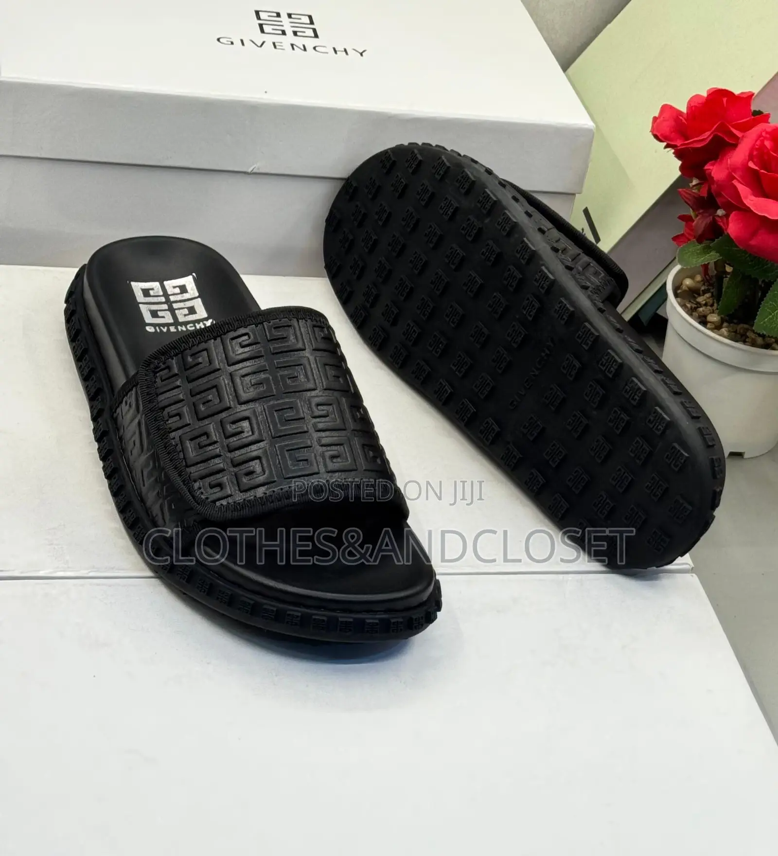 Black Givenchy Slides Feature a Prominent Monogram Embossed Pattern